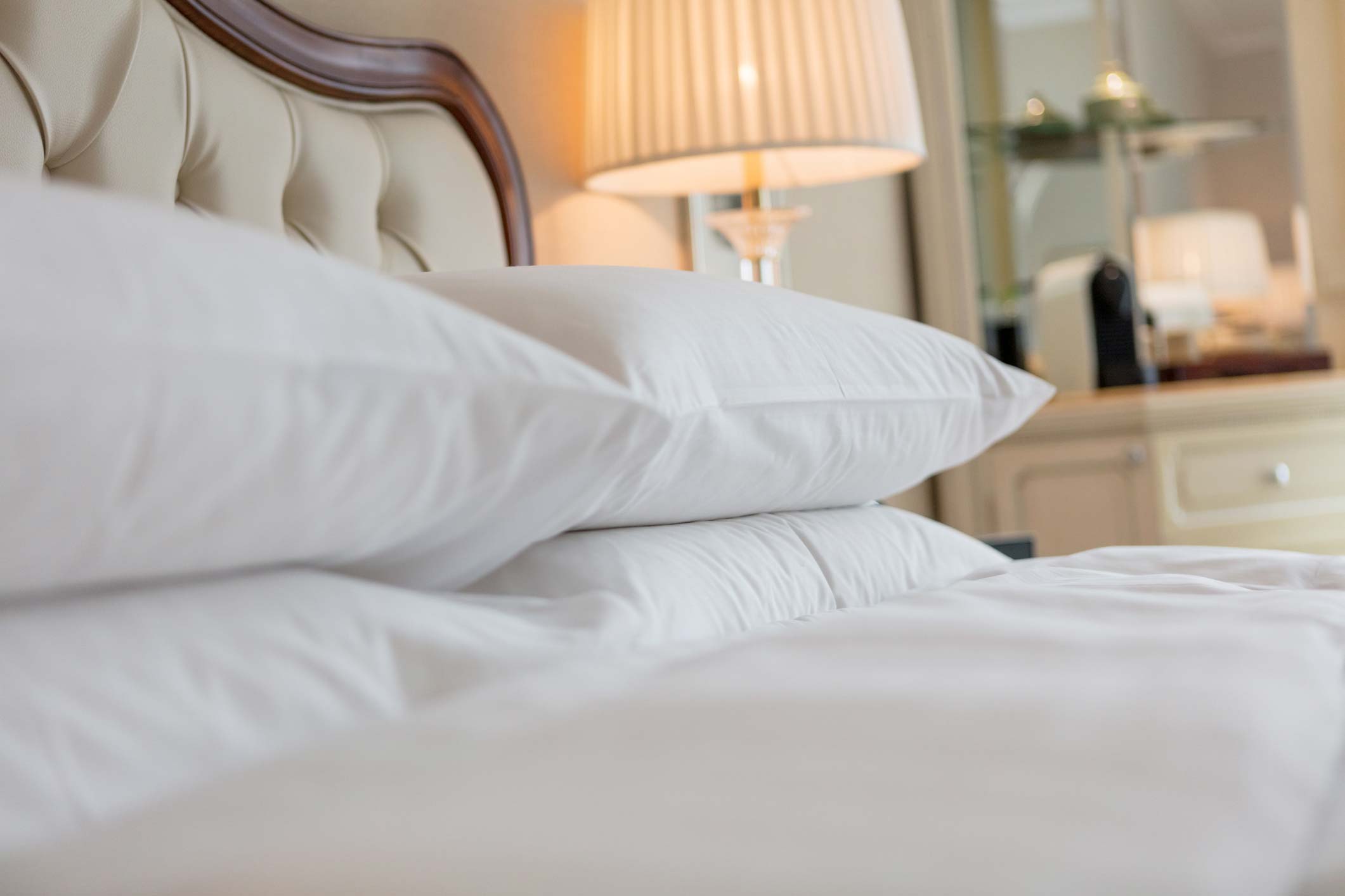 Close-up of the bed linen in a room at Château Les Oliviers de Salettes, a charming hotel in Charols.